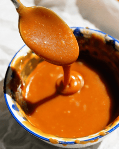 salted caramel sauce dripping from spoon