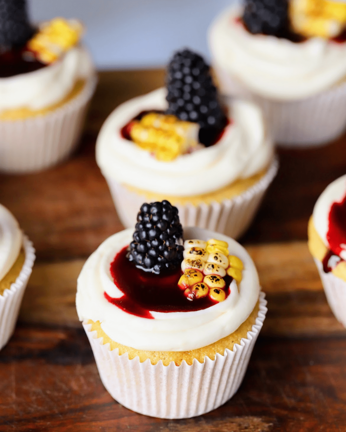 cornbread cupcakes frosted with a whipped honey buttercream and blackberry compote