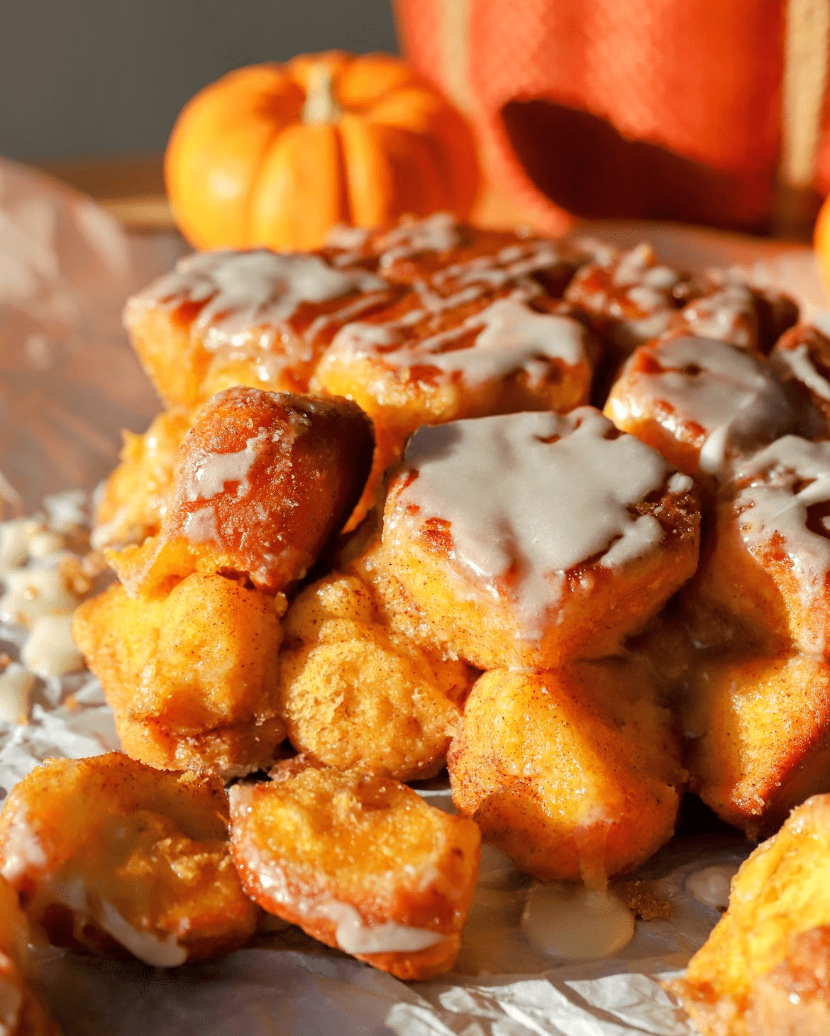 brown butter pumpkin monkey bread pulled apart with cream cheese glaze