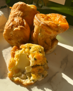 Three Cheese Jalapeno Popovers topped with butter and honey.
