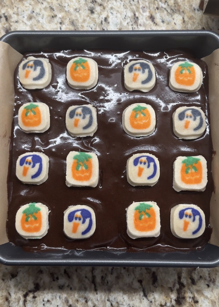 unbaked assembled slutty brownies in a 9x9 pan, ready to be baked